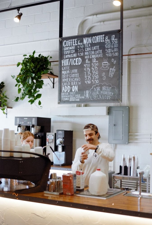 Barista under the chalkboard menu