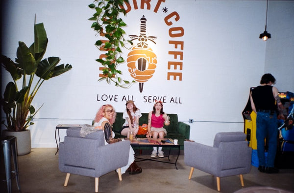 Friends hanging out under the Honey Dirt mural