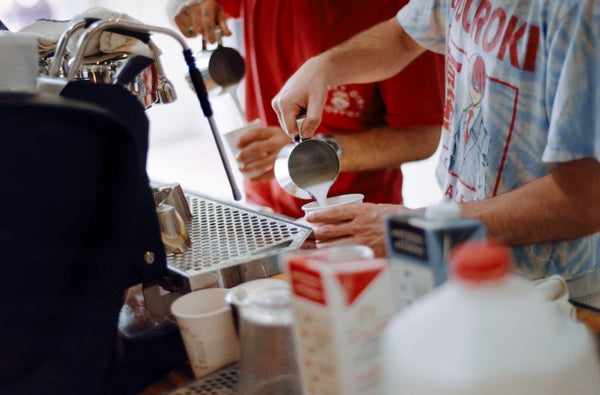 Steamed milk going into a cup